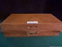 Closed wooden case with carry handle