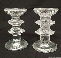 Front view of both textured glass candle holders standing upright