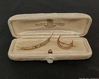 Pair of crescent brooches in Ryrie Birks box, closed view