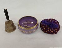 Bell, singing bowl, and cushion front view