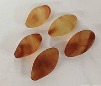 Five banded agate eggs grouped on white background