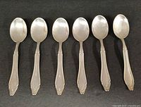 front view of six identical 4-inch 800 silver spoons