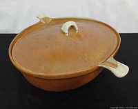 Casserole with lid in place showing exterior glaze and handles