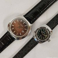 Front view of both watches showing dials, straps and relative sizes