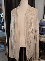 Full view of cream Aran knit cardigan on mannequin