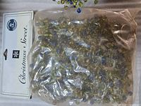 Sealed bag labeled Christmas Street containing beaded garland