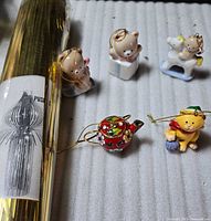 Full lot: cloisonné teapot, resin cat, three porcelain bears, gold tinsel tube