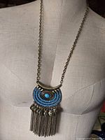 Full view of necklace on mannequin showing chain and pendant size