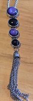Full view of pendant showing four cabochon stones and tassel on silver-tone chain