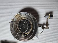 Top view of metal radiant head with wire guard and mounting arm