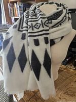 Scarf draped on mannequin showing size and pattern