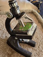 Full view of microscope showing base, stage, eyepiece