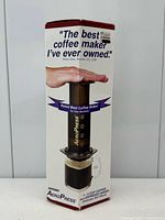 Front of sealed AeroPress retail box showing product image and capacity