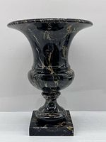 Front view of black marble urn planter showing overall form and veining
