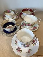 All five teacup and saucer sets grouped