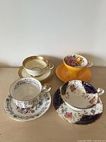 All four teacup and saucer pairs displayed