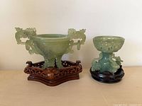 Both green stone censers on their wood stands