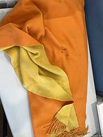 orange side of shawl with visible stains