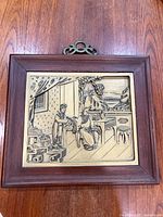 Front view showing wood frame and carved panel