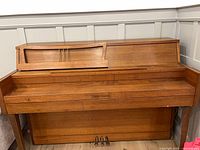 Front view of Heintzman upright piano showing cabinet and pedals