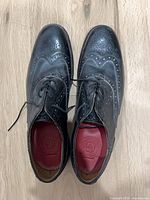 Top view showing both shoes, brogue detailing, laces, red insoles with G logo