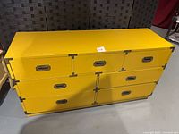 Front view showing 7 drawers, recessed pulls and corner brackets