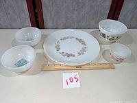 Group shot of all five milk glass pieces with ruler for scale