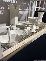 Shelf showing entire assortment of Lenox ivory porcelain pieces