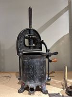 Front view showing full sausage stuffer, vertical screw, base legs