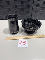 Overall shot showing both black glass pieces with ruler for scale