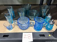 Group shot of all 14 blue and aqua glass pieces