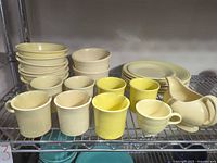 Full lot showing cups, plates, bowls, creamer