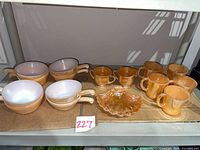 Group shot of all peach luster pieces on shelf
