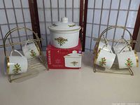 Full set showing treat jar on box, six mugs on two gold-tone stands