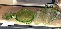 Full group shot of all seven green glass pieces