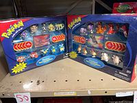 Both sealed battle sets side by side on shelf