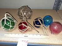 All six floats lined with ruler for scale