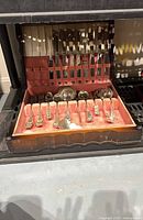 Overall view of flatware set in open chest showing utensils and interior