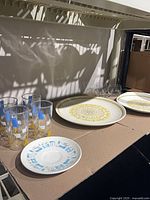 Shelf view showing 5 tall tumblers, 2 large Sierra plates, 4 short glasses, 1 small plate