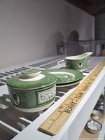 Overview showing three of four pieces with ruler for scale