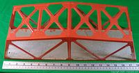 Top view of orange truss bridge with ruler showing 18 in. length