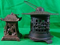 Two cast iron pagoda-style lanterns front view