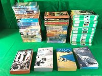 Stacked view of all 41 Jules Verne books showing three columns of softcovers and hardcovers plus four front-facing volumes