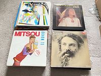 Stack of records topped by Lambada, Celine Dion Les Plus Grands Succes, Mitsou El Mundo, Georges Moustaki Bobino 70