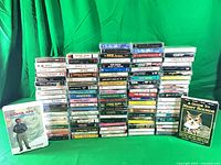 Full lot showing three stacks of cassette tapes plus two boxed sets
