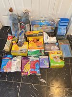 Group shot of entire lot on floor, showing cleaning cloths, gloves, garbage bags, sponges, mop heads