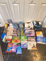 Overview of lot showing steel wool, garbage bags, gloves, sponges, mop heads