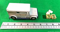 Side view of Dinky 275 Brinks truck next to ruler and accessories