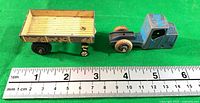 Side view of tractor cab and trailer with ruler for scale