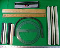 All drafting items laid out on green background